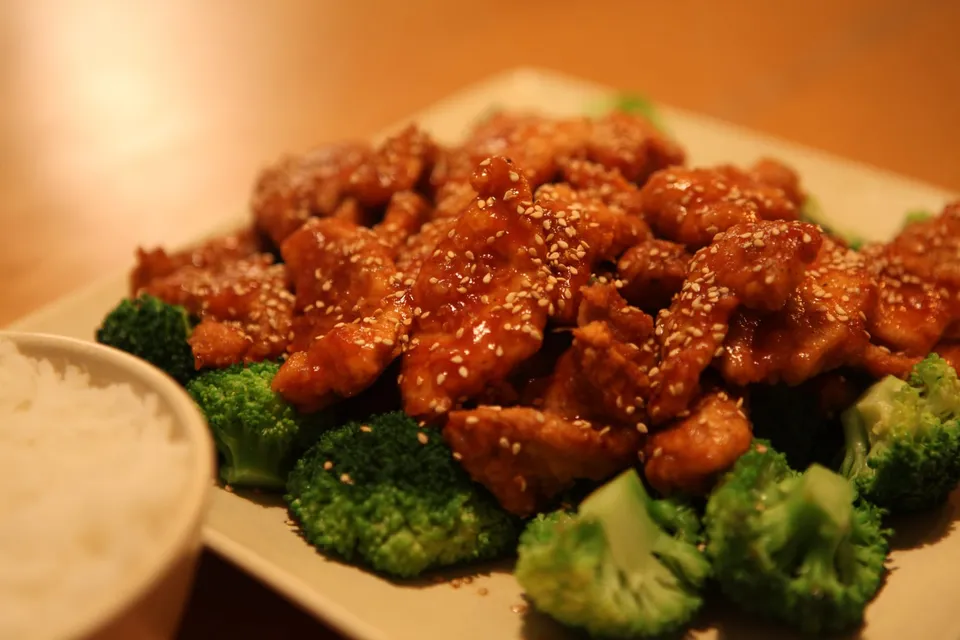 Glazed chicken pieces with broccoli florets and rice